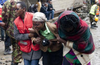 <p>A Kenyan Red Cross worker and a volunteer console a relative of a victim at the site of a building collapse in Nairobi, Kenya, April 30, 2016. (<i>Photo: Sayyid Abdul Azim/AP)</i></p>