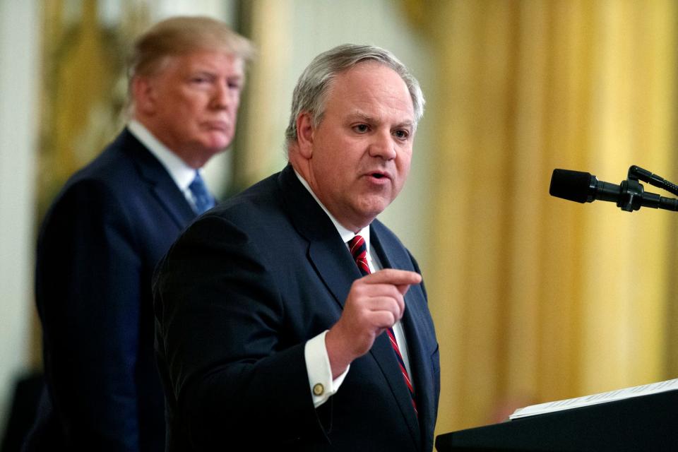 President Donald Trump listens July 8 as Secretary of the Interior David Bernhardt speaks during an event on the environment in the White House in Washington.