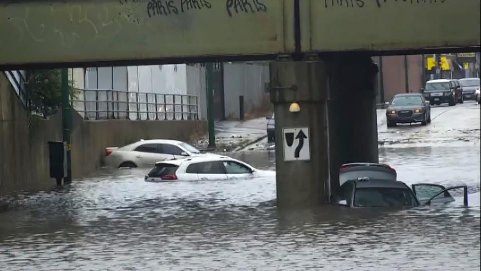 Several vehicles are stranded in the flooded viaduct at Fifth and Cicero Avenues in Chicago.