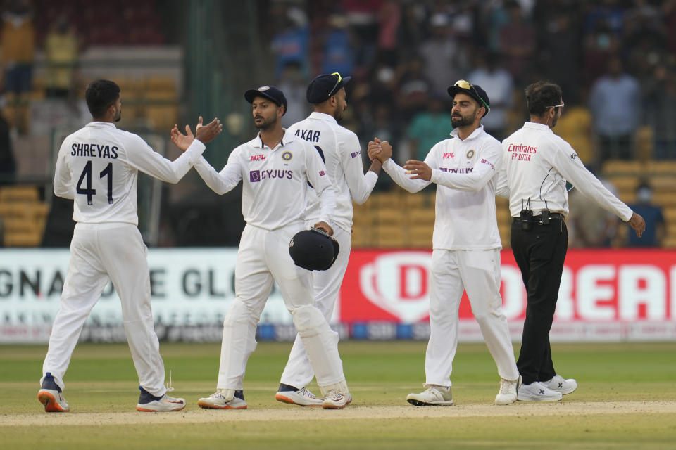 Indian players greet each other after their win on the third day of the second cricket test match against Sri Lanka in Bengaluru, India, Monday, March 14, 2022. (AP Photo/Aijaz Rahi)