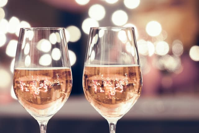 Wine glasses against bokeh background. New Year's celebration.