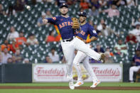 Houston Astros third baseman Alex Bregman, front, makes the play to first base in front of shortstop Jeremy Pena, back, on the grounder by Oakland Athletics' Max Schuemann during the fifth inning of a baseball game Wednesday, May 15, 2024, in Houston. (AP Photo/Michael Wyke)