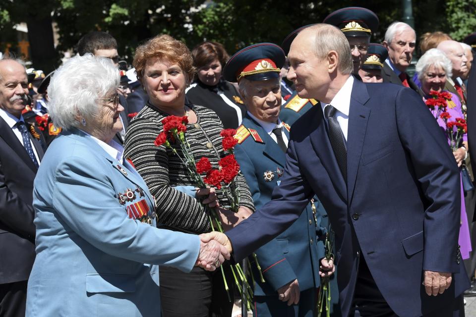 Russian President Vladimir Putin, right, greets a WWII veteran as he arrives to take part in a wreath laying ceremony at the Tomb of Unknown Soldier in Moscow, Russia, Monday, June 22, 2020, marking the 79th anniversary of the Nazi invasion of the Soviet Union. (Alexei Nikolsky, Sputnik, Kremlin Pool Photo via AP)