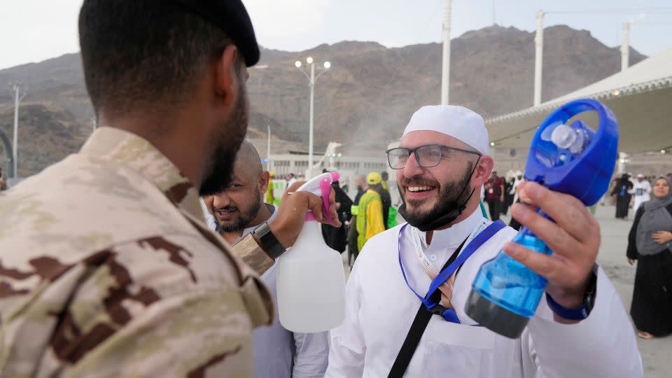 A pilgrim receives cold water spray in Mina near the holy city of Mecca - Rafiq Maqbool/AP