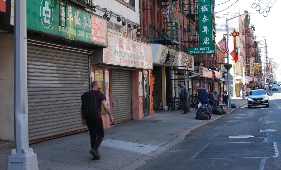 A man walks through a quiet Mott Street on May 17. Employees have expressed concern in traveling from the outer boroughs into NYC Chinatown for work. Photo: Brian Cheung / Yahoo Finance