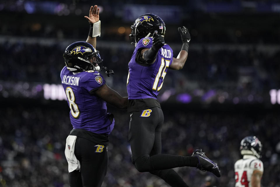 Baltimore Ravens wide receiver Nelson Agholor (15) celebrates his touchdown catch with quarterback Lamar Jackson (8) during the first half of an NFL football AFC divisional playoff game against the Houston Texans, Saturday, Jan. 20, 2024, in Baltimore. (AP Photo/Matt Slocum)