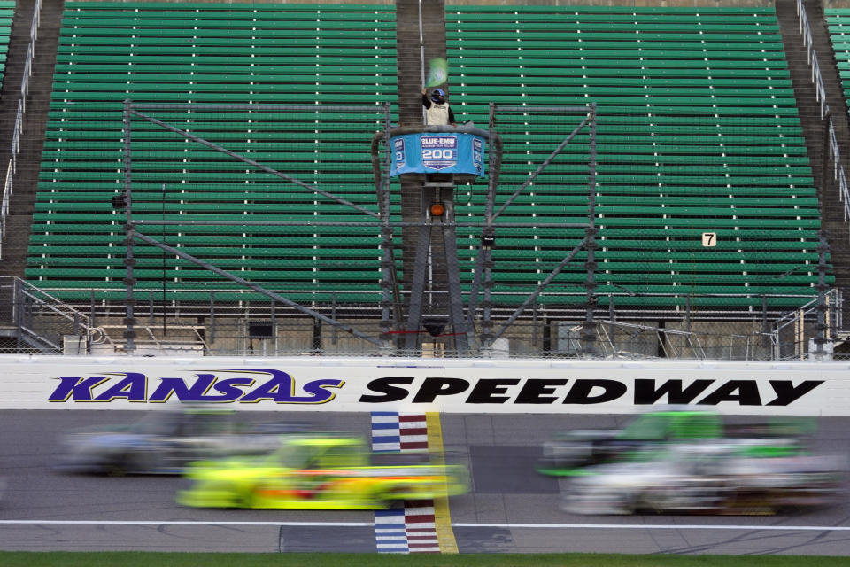 Drivers take the green flag at the start of a NASCAR Truck Series auto race at Kansas Speedway in Kansas City, Kan., Friday, July 24, 2020. (AP Photo/Charlie Riedel)