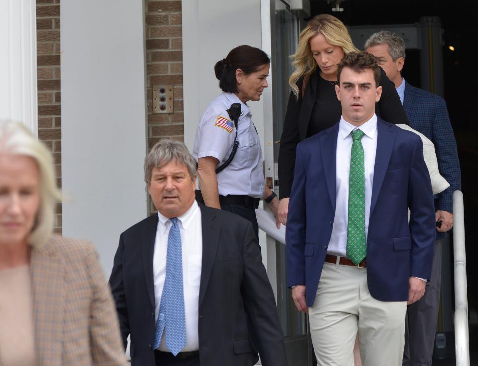 David Sullivan, right, walks out of Barnstable Superior Court with his attorney David Meier, second from left, and others who attended his arraignment Tuesday morning. Sullivan was indicted in connection with the Sesuit Harbor boat crash that killed 17-year-old Sadie Mauro July 21, 2023.