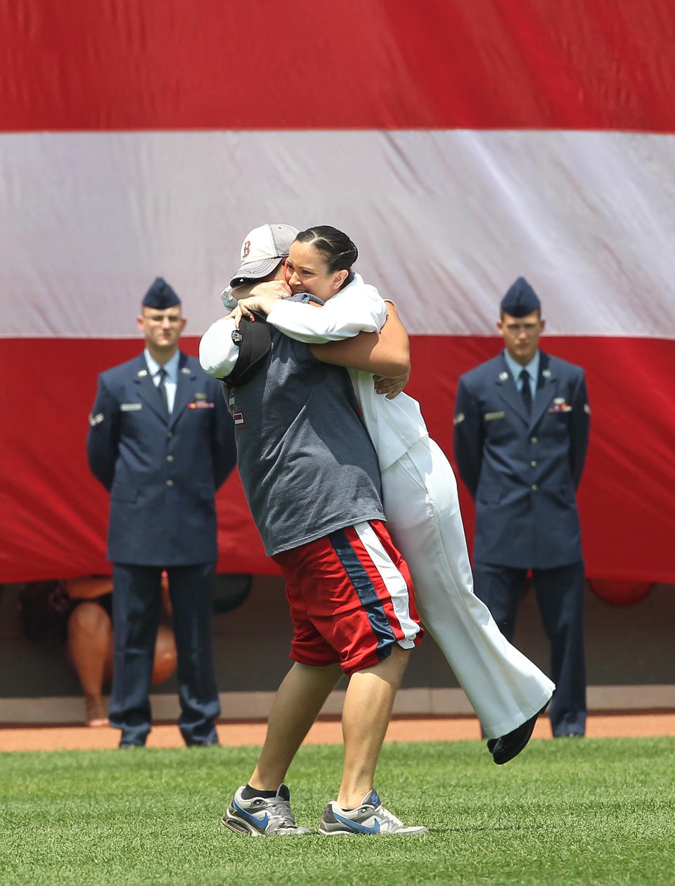 <p>Petty Officer Bridget is hugged before a game between the Boston Red Sox and the Toronto Blue Jays at Fenway Park on July 4, 2011 in Boston, Massachusetts. With her family in attendance, Lydon made a surprise visit from her ship, the USS Ronald Reagan, as the Red Sox honored America’s military personnel on the Fourth of July. (Photo by Jim Rogash/Getty Images) </p>