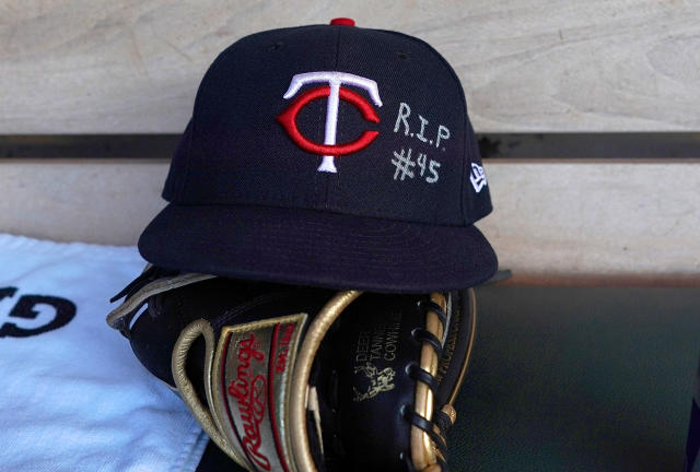 Miguel Gonzalez places a hat at a memorial for Los Angeles Angels pitcher Tyler  Skaggs outside Angel Stadium in Anaheim, Calif., Tuesday, July 2, 2019. The  27-year-old left-hander died in his Texas