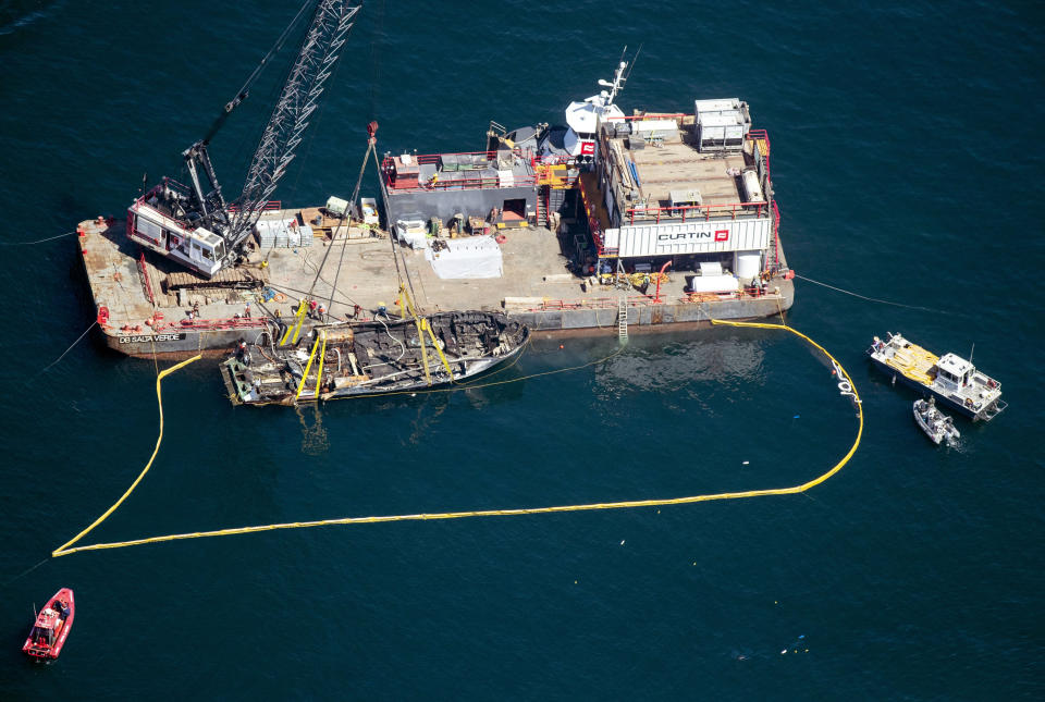 The burned hull of the Conception is brought to the surface by a salvage team, Thursday, Sept. 12, 2019, off Santa Cruz Island, Calif., in the Santa Barbara Channel in Southern California. The vessel burned and sank on Sept. 2, taking the lives of 34 people aboard. Five survived. (Brian van der Brug/Los Angeles Times via AP)