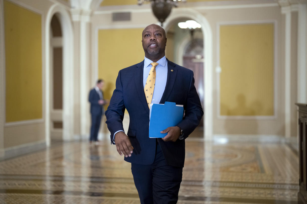 Sen. Tim Scott, R-S.C., walks past the chamber during the vote to confirm former Los Angeles Mayor Eric Garcetti as the next ambassador to India, more than a year and a half after he was initially selected for the post, at the Capitol in Washington, Wednesday, March 15, 2023. (AP Photo/J. Scott Applewhite)