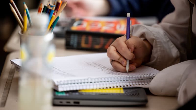 A student takes notes during an English class at Cyprus High School in Magna on Friday, Jan. 27, 2023.