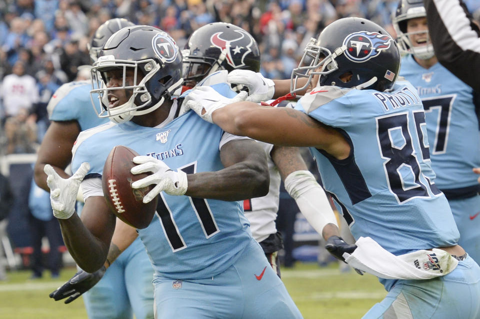 Tennessee Titans wide receiver A.J. Brown (11) celebrates with MyCole Pruitt (85) after Brown scored a touchdown against the Houston Texans in the second half of an NFL football game Sunday, Dec. 15, 2019, in Nashville, Tenn. (AP Photo/Mark Zaleski)