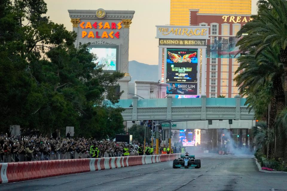 Nov 5, 2022; Las Vegas, Nevada, USA; Mercedes-AMG Petronas driver George Russell drives on the track during the Formula One Las Vegas Grand Prix Launch Party at Las Vegas Strip. Mandatory Credit: Ray Acevedo-USA TODAY Sports