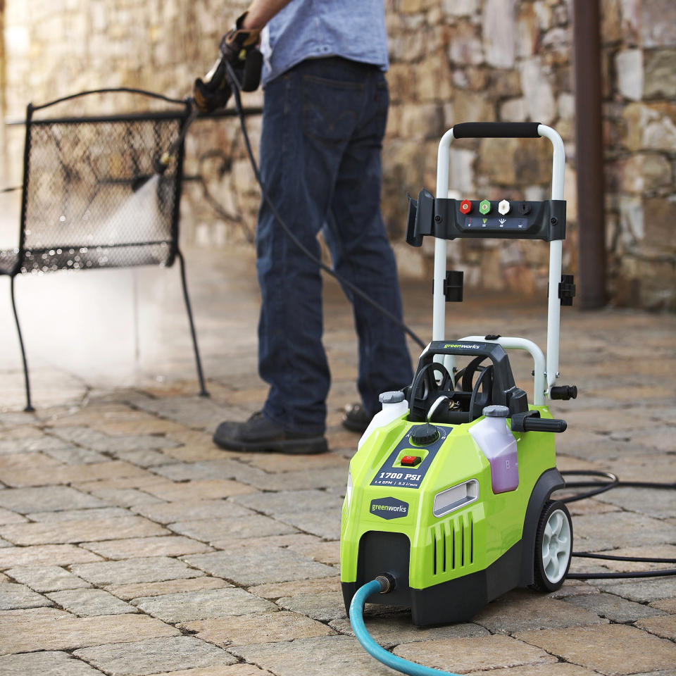 This July 9, 2013 publicity photo provided by Lowe's Home Improvement shows a Greenworks 1700 PSI ,1.4 GPM Electric Pressure Washer being used to clean a patio chair. Lowe's Home Improvement spokeswoman Colleen Maiura said, "Monthly cleaning and maintenance can help the furniture maintain a good appearance and make your investment last longer." (AP Photo/Lowe's Home Improvement)