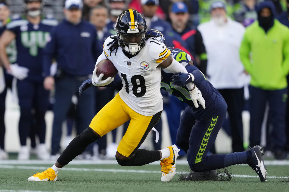 FILE - Pittsburgh Steelers wide receiver Diontae Johnson (18) tries to get past Seattle Seahawks cornerback Devon Witherspoon (21) in the first half of an NFL football game Sunday, Dec. 31, 2023, in Seattle. The Carolina Panthers have surrounded Bryce Young with highly paid offensive linemen and some new offensive weapons including Johnson after a season in which they went 2-15. (AP Photo/Lindsey Wasson, File)