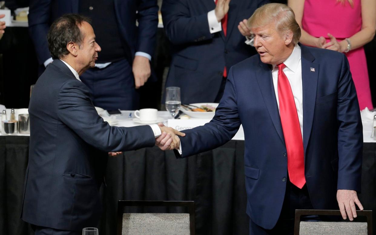 Mr Trump with billionaire hedge fund manager John Paulson