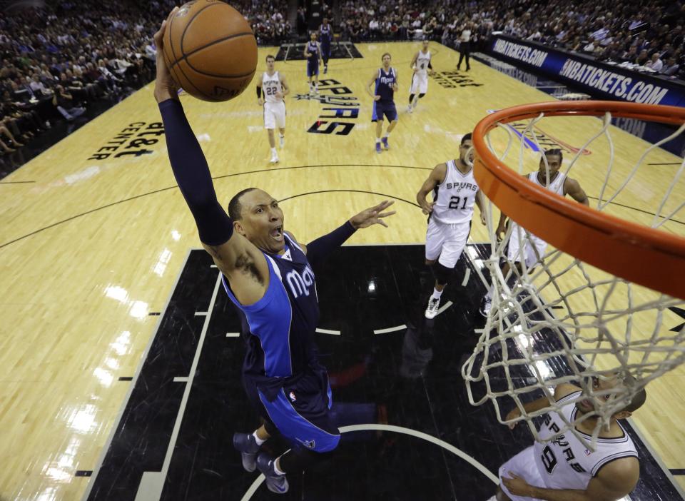 Dallas Mavericks' Shawn Marion (0) drives to the basket over San Antonio Spurs' Tony Parker (9), of France, during the first half of Game 2 of the opening-round NBA basketball playoff series on Wednesday, April 23, 2014, in San Antonio. (AP Photo/Eric Gay)