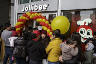 MILAN, ITALY - APRIL 11: Customers queue in front of a Jollibee restaurant on April 11, 2018 in Milan, Italy. Jollibee Food Corporation, a Filipino chain of fast food restaurants and the largest Asian food services company, has chosen Milan, home of the biggest Filipino community in Europe, to open its first European branch. (Photo by Emanuele Cremaschi / Getty Images)