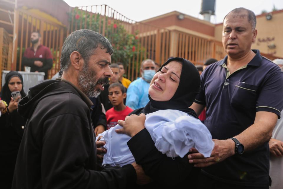 People mourn as they collect the bodies of Palestinians killed in Israeli air raids on Oct. 28, 2023, in Khan Yunis, Gaza. Heading into a third week of heavy bombing from Israel, Gaza buckles under a shortage of basic needs, including fuel. At the same time, several neighborhoods in the Gaza strip have been wiped out, thousands have died, and hundreds of thousands have been displaced. On Oct. 7, Hamas launched a deadly attack in southern Israel that sparked a retaliatory siege of Gaza.