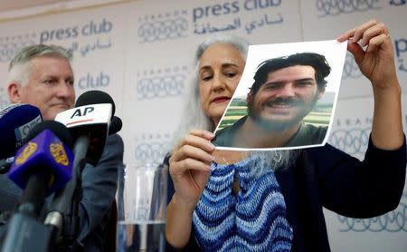 Debra Tice, the mother of American journalist Austin Tice, holds a picture of him as his father Marc Tice looks on during a news conference in Beirut, Lebanon July 20, 2017. REUTERS/Jamal Saidi