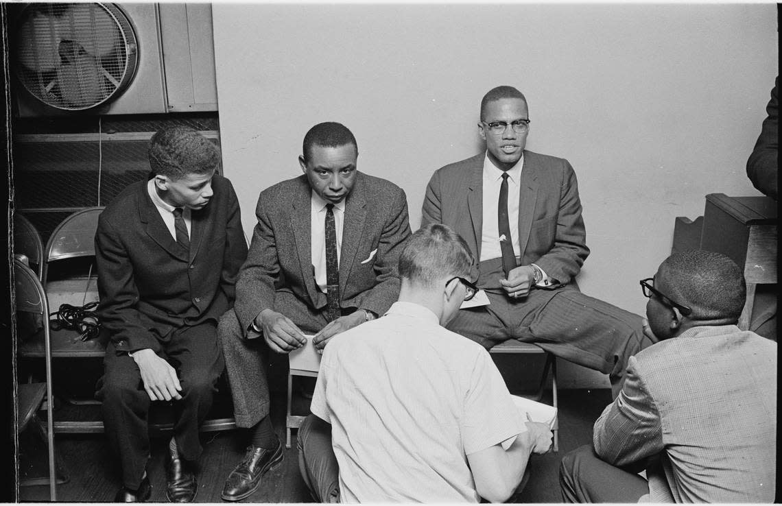 Durham attorney and civil rights activist Floyd McKissick Sr., left, looking at camera, and black nationalist Malcolm X, right, debated in Durham in 1963.