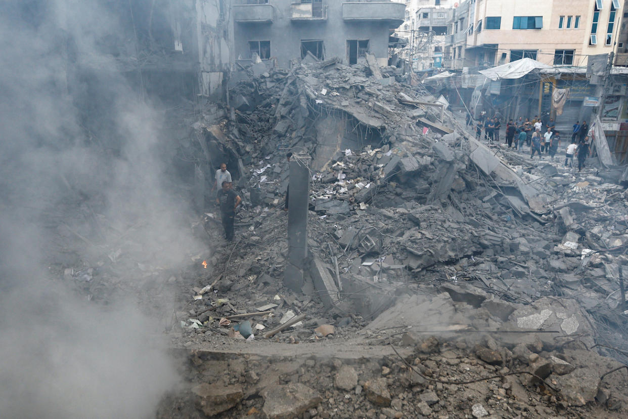 Palestinians inspect the damage in the aftermath of Israeli strikes, in Khan Younis, southern Gaza Strip October 10, 2023. (PHOTO: REUTERS/Ibraheem Abu Mustafa)