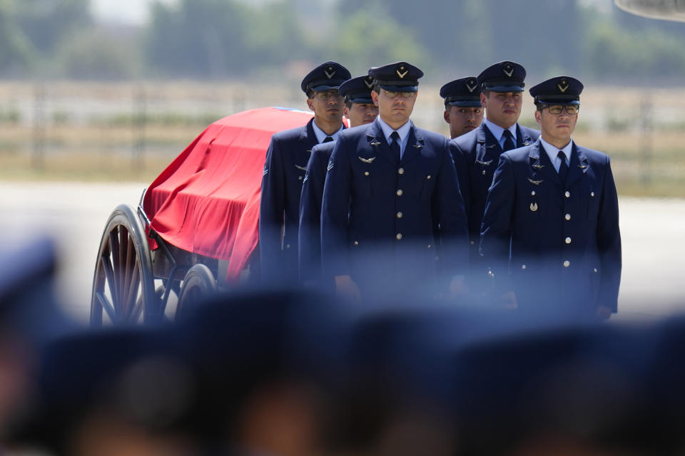 The remains of former Chilean President Sebastian Pinera arrive at the airport to be taken to Congress in Santiago, Chile, Wednesday, Feb. 7, 2024. The two-time former president died on Feb. 6 in a helicopter crash. He was 74. (AP Photo/Esteban Felix)