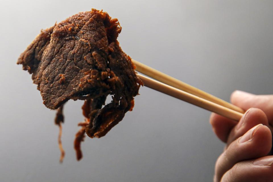 Beef jerky held with chopsticks