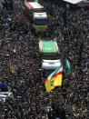 Iranians follow trucks carrying coffins of the late President Ebrahim Raisi and his companions who were killed in a helicopter crash on Sunday in a mountainous region of the country's northwest, during a funeral ceremony for them in Tehran, Iran, Wednesday, May 22, 2024. Iran's supreme leader presided over the funeral Wednesday for the country's late president, foreign minister and others killed in the helicopter crash, as tens of thousands later followed a procession of their caskets through the capital, Tehran. (AP Photo/Vahid Salemi)