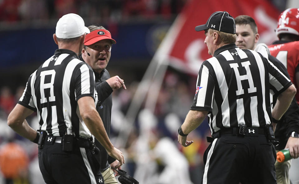FILE - In this Dec. 1, 2018, file photo, Georgia head coach Kirby Smart, second from left,  speaks with officials during the first half of the Southeastern Conference championship NCAA college football game against Alabama, in Atlanta. The Southeastern Conference hired international accounting firm Deloitte to conduct a review of its football officiating. Commissioner Greg Sankey says the move was a reaction in part to the often opinionated view of referees by the public and media. (AP Photo/John Amis, File)
