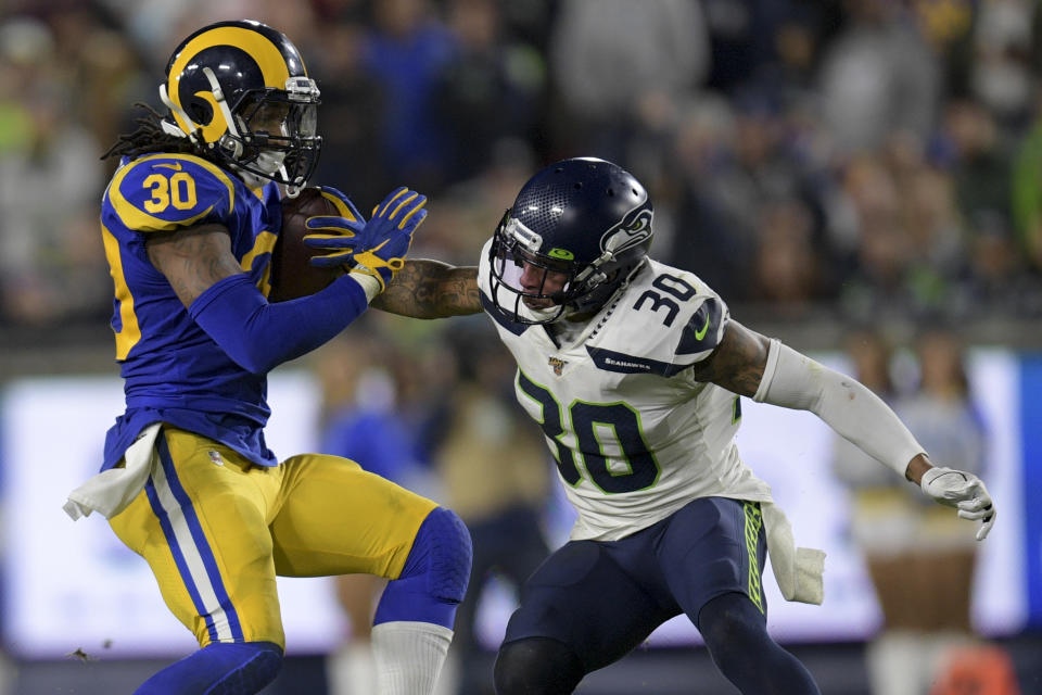 Los Angeles Rams running back Todd Gurley, left, runs past Seattle Seahawks strong safety Bradley McDougald during the second half of an NFL football game Sunday, Dec. 8, 2019, in Los Angeles.(AP Photo/Kyusung Gong)
