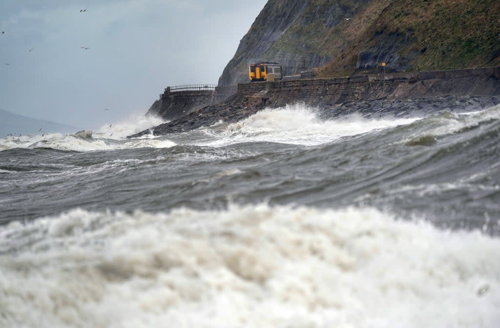 A train on west coast between Whitehaven and Carlisle in February. Insurers expect the bill for damage caused by Storms Dudley, Eunice and Franklin that hit much of the UK during February to amount to nearly £500 million (Owen Humphreys/PA) (PA Wire)