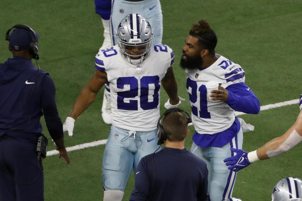 Dallas Cowboys' Tony Pollard and running back Ezekiel Elliott (21) celebrate Pollard's touchdown run in the first half of a preseason NFL football game against the Houston Texans in Arlington, Texas, Saturday, Aug. 21, 2021. (AP Photo/Roger Steinman)