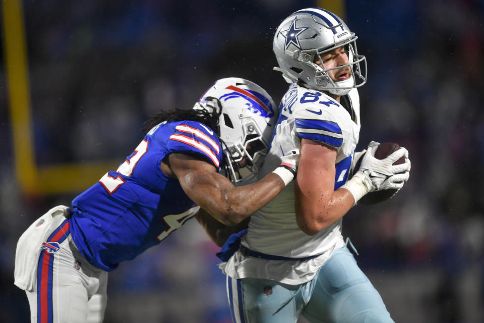 Buffalo Bills linebacker Dorian Williams (42) puts a hit on Dallas Cowboys tight end Jake Ferguson (87) during the fourth quarter of an NFL football game, Sunday, Dec. 17, 2023, in Orchard Park, N.Y. (AP Photo/Adrian Kraus)