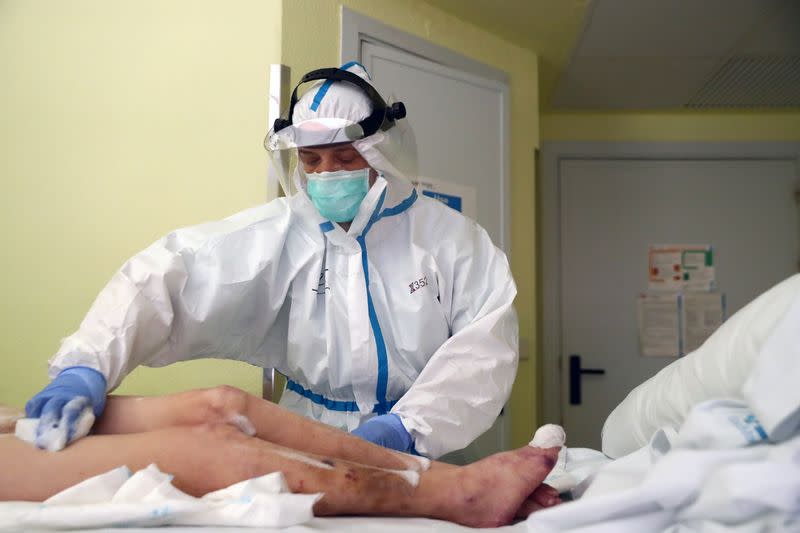 La enfermera Cristina Cadenas, de 53 años, con un equipo de protección personal (PPE) completo, atiende a un paciente durante su turno en el hospital Príncipe de Asturias, en medio del brote de la enfermedad coronavirus (COVID-19), en Alcalá de Henares, España