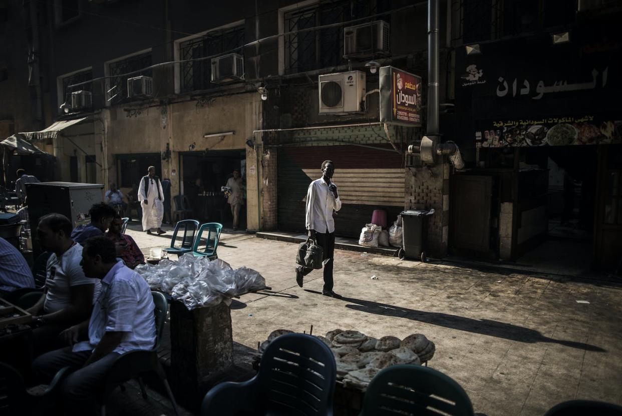 A cafe in Cairo, Egypt, that is predominantly visited by Sudanese migrants, in August 2017. <a href="https://www.gettyimages.com/detail/news-photo/man-walks-by-a-sudanese-flag-near-a-cafe-that-predominantly-news-photo/991484150?adppopup=true" rel="nofollow noopener" target="_blank" data-ylk="slk:Oliver Weiken/picture alliance via Getty Images;elm:context_link;itc:0;sec:content-canvas" class="link ">Oliver Weiken/picture alliance via Getty Images</a>