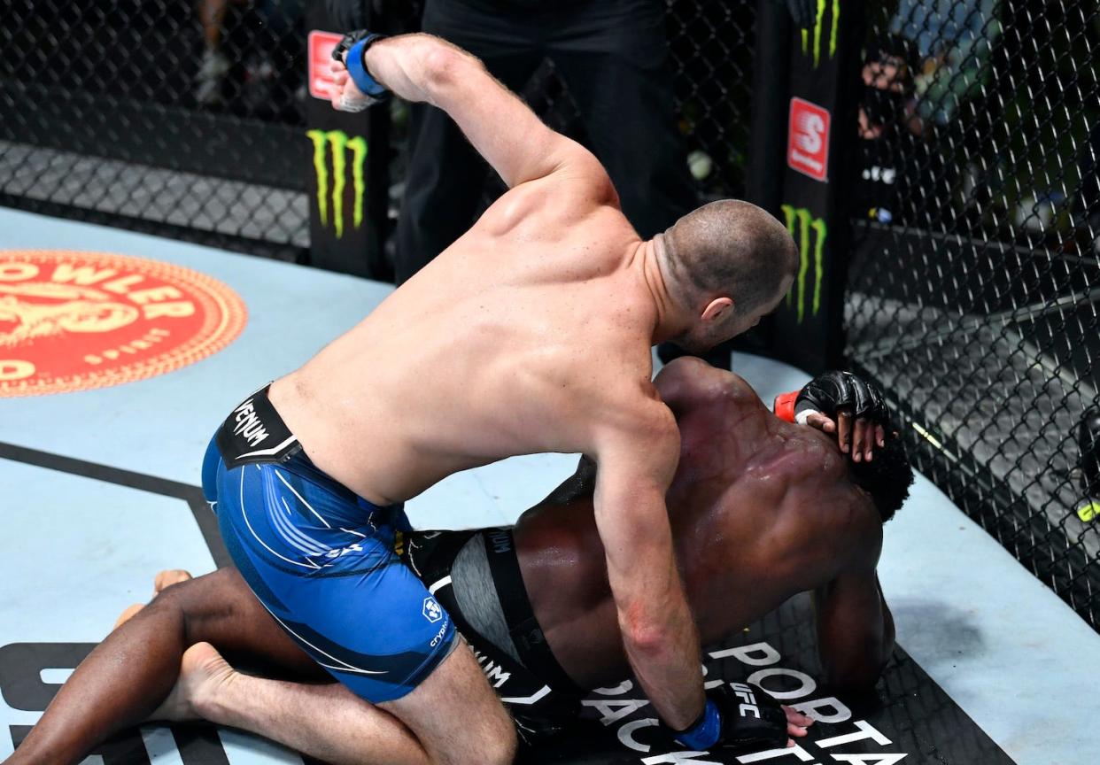 Sean Strickland punches Uriah Hall during their UFC middleweight fight Saturday.