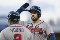 Atlanta Braves' Travis d'Arnaud celebrates after getting a base hit during the first inning of a baseball game against the Miami Marlins, Tuesday, Oct. 4, 2022, in Miami. (AP Photo/Wilfredo Lee)