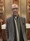 The Rev. Darryl Gray stands in front of a cross on Jan. 10, 2023, in St. Louis, Mo. Gray served as the spiritual adviser for Missouri inmate Kevin Johnson, and was in the execution room when Johnson was put to death in November for killing a suburban St. Louis police officer. Spiritual advisers have been increasingly alongside condemned inmates at executions since a Supreme Court ruling last year required states to allow them to both be present and touch the inmate. (AP Photo/Jim Salter)