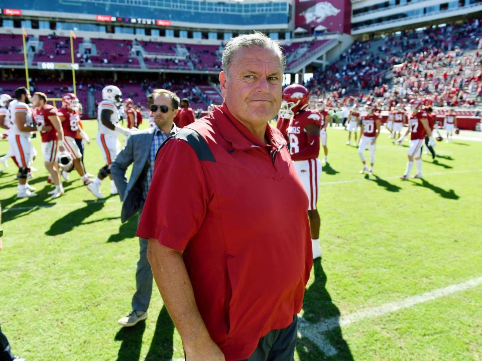 Sam Pittman looks on while walking across the field during a game in 2021.