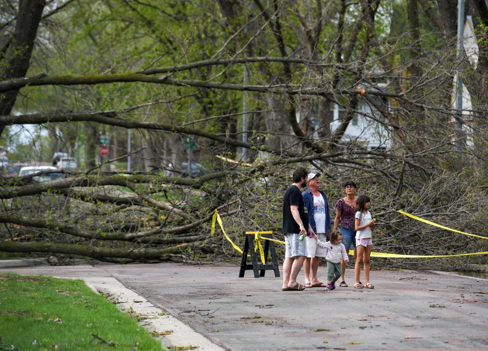 Neighbors look at storm damage in the McKennan neighborhood on Thursday, May 12, 2022, in Sioux Falls.