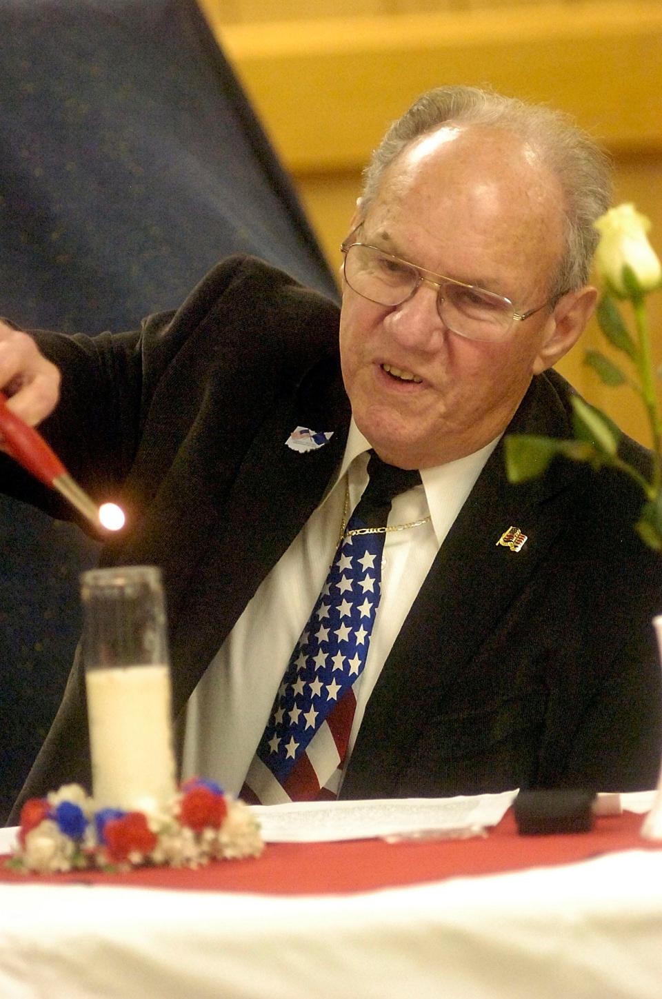 Don Earlenbaugh lights a candle for George Fox during the Four Chaplains Service held in February 2018 at Harrry Higgins Post 88.