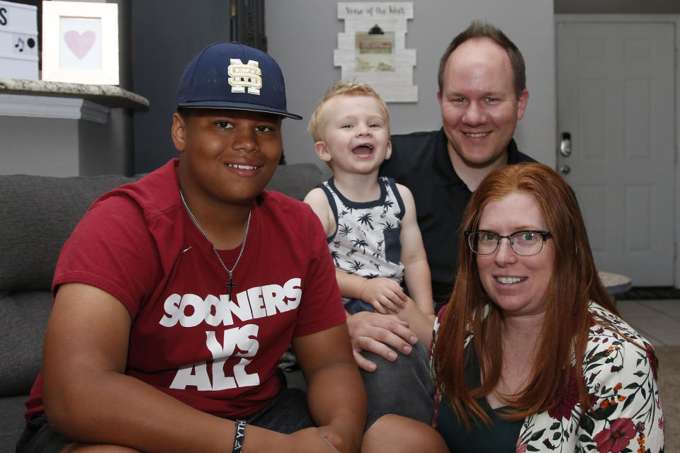 The Dunn family is pictured in their home Friday, June 12, 2020, in Oklahoma City. From left are Izzy Simons, Cooper Dunn, Josh Dunn and Sarah Dunn. Sarah Dunn, who grew up in rural Kansas, has learned much about race since she and her husband, Josh, took custody of Izzy six years ago. (AP Photo/Sue Ogrocki)