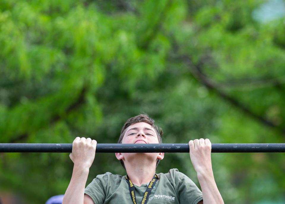 A festivalgoer tried his hand(s) at pullups at Waterfront Park at the Kentucky Derby Festival's Thunder Over Louisville on Saturday, April 22, 2023