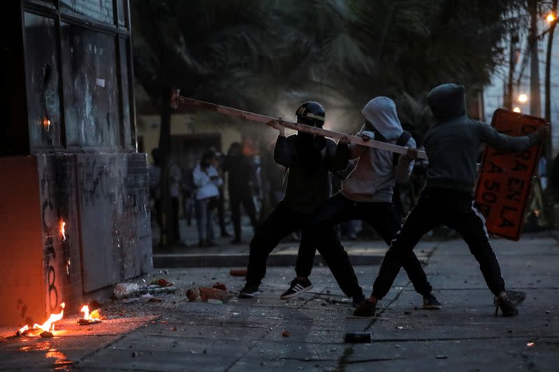 People vandalize the exterior of a police station during a protest after a man, who was detained for violating social distancing rules, died from being repeatedly shocked with a stun gun by officers, according to authorities, in Bogota