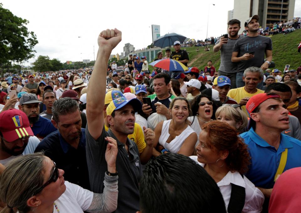 <p>Venezuela’s opposition leader and Governor of Miranda state Henrique Capriles (L) poses for a picture with supporters during a blockade in an avenue while rallying against President Nicolas Maduro in Caracas, Venezuela, May 15, 2017. (Marco Bello/Reuters) </p>