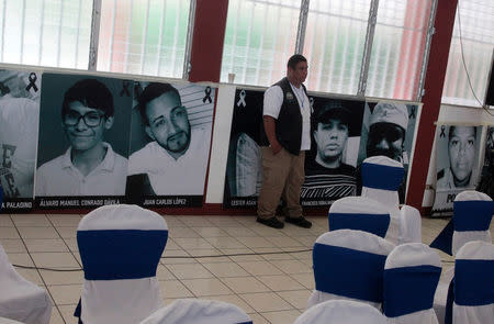 A man stands in front of photographs of the victims killed in recent protests over reforms that implemented changes in the pension plans of the Nicaraguan Social Security Institute (INSS) during national dialogue in Managua, Nicaragua June 16, 2018. REUTERS/Jorge Cabrera