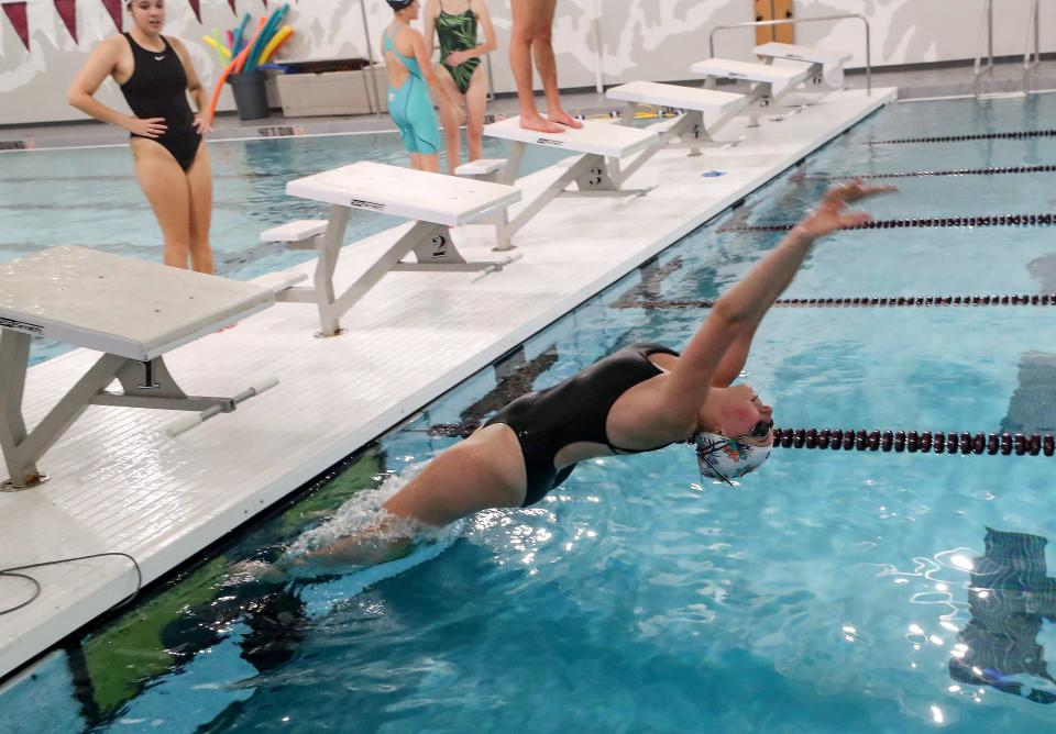 South Kitsap’s Azaline Spiker pushes off the wall while practicing her backstroke starts during practice at the renovated pool at South Kitsap High School in Port Orchard on Wednesday, Oct. 18, 2023.